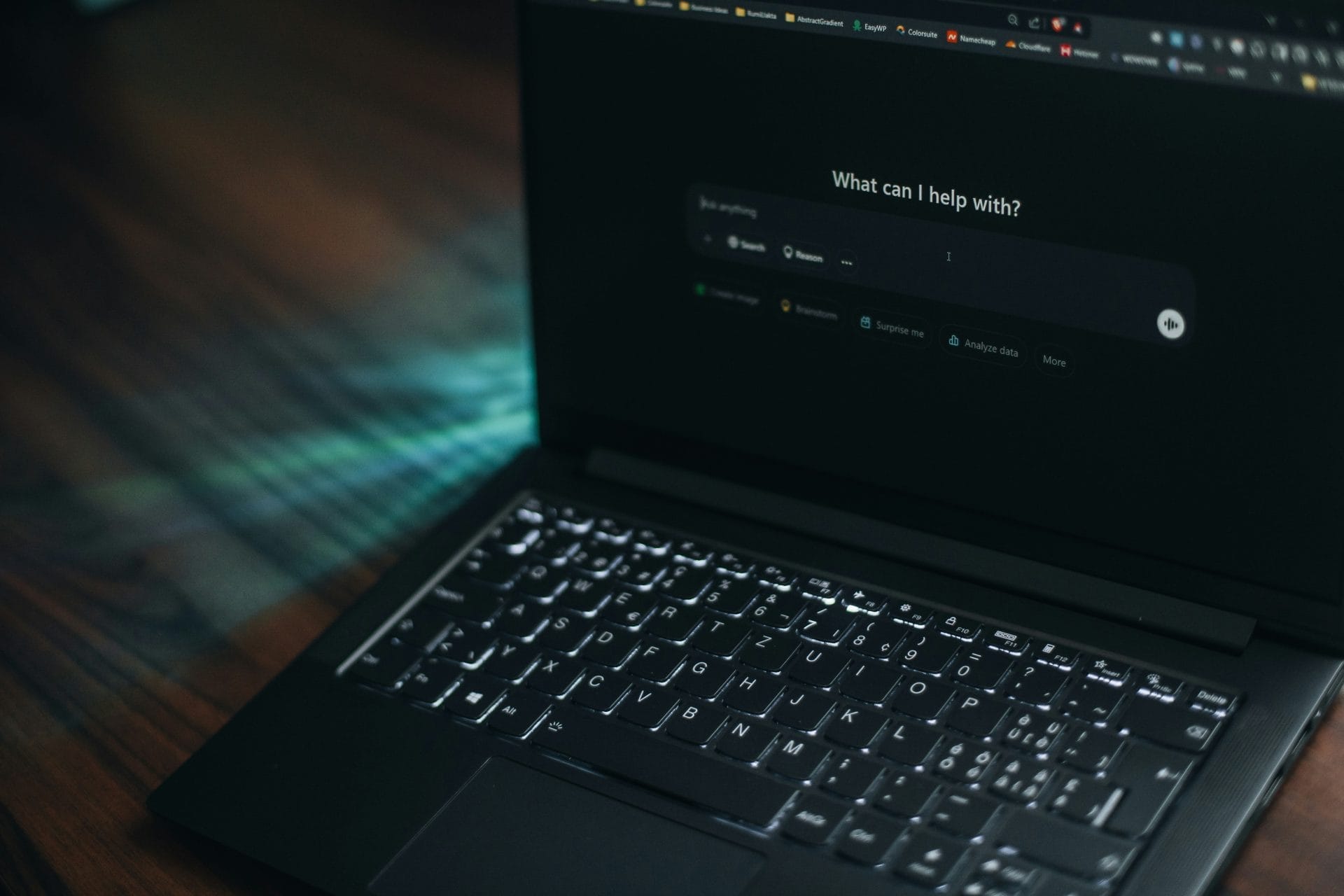 Laptop with a dark-themed AI assistant interface on screen.